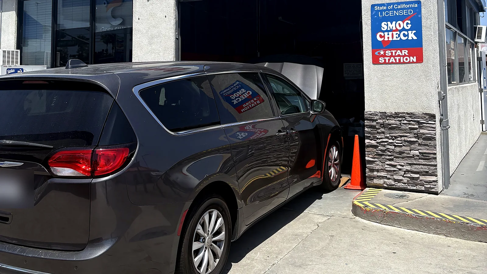 Change-of-ownership smog check in Escondido, CA: minivan pulling into our test bay