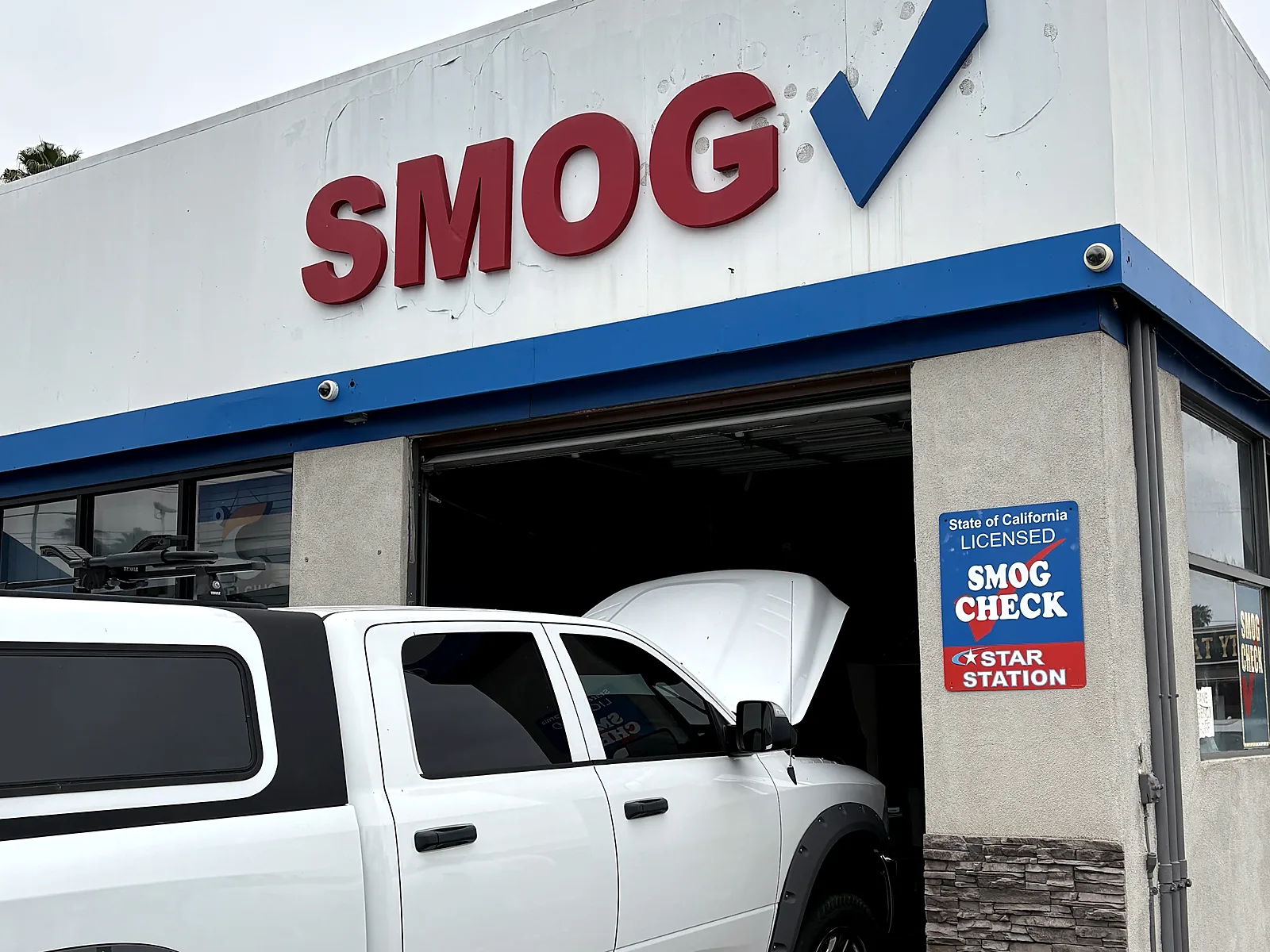 Diesel smog check in Escondido, CA: pickup truck in our test bay under the Smog sign