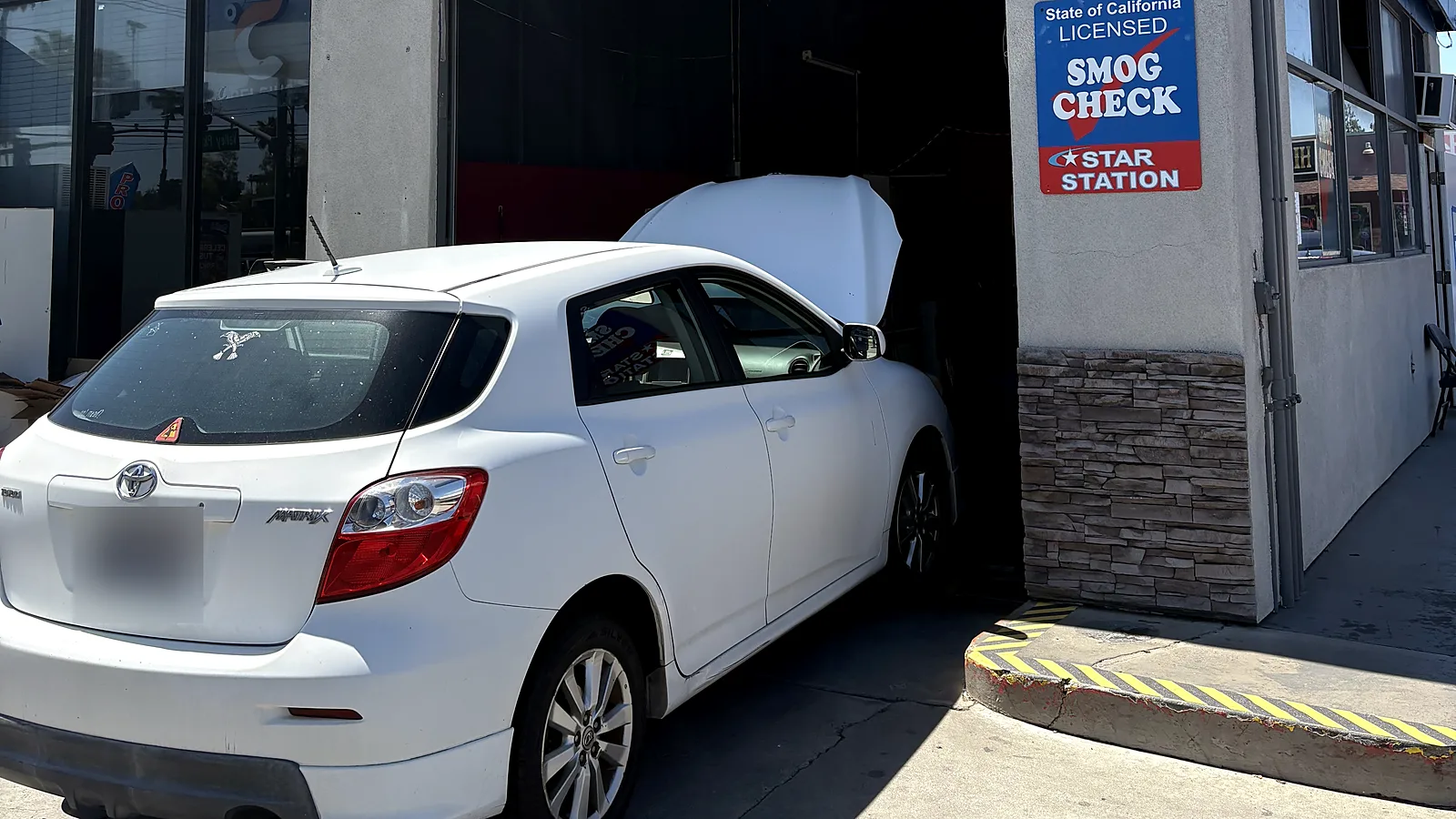 Hybrid smog check in Escondido, CA: Toyota Matrix with the hood up in our test bay