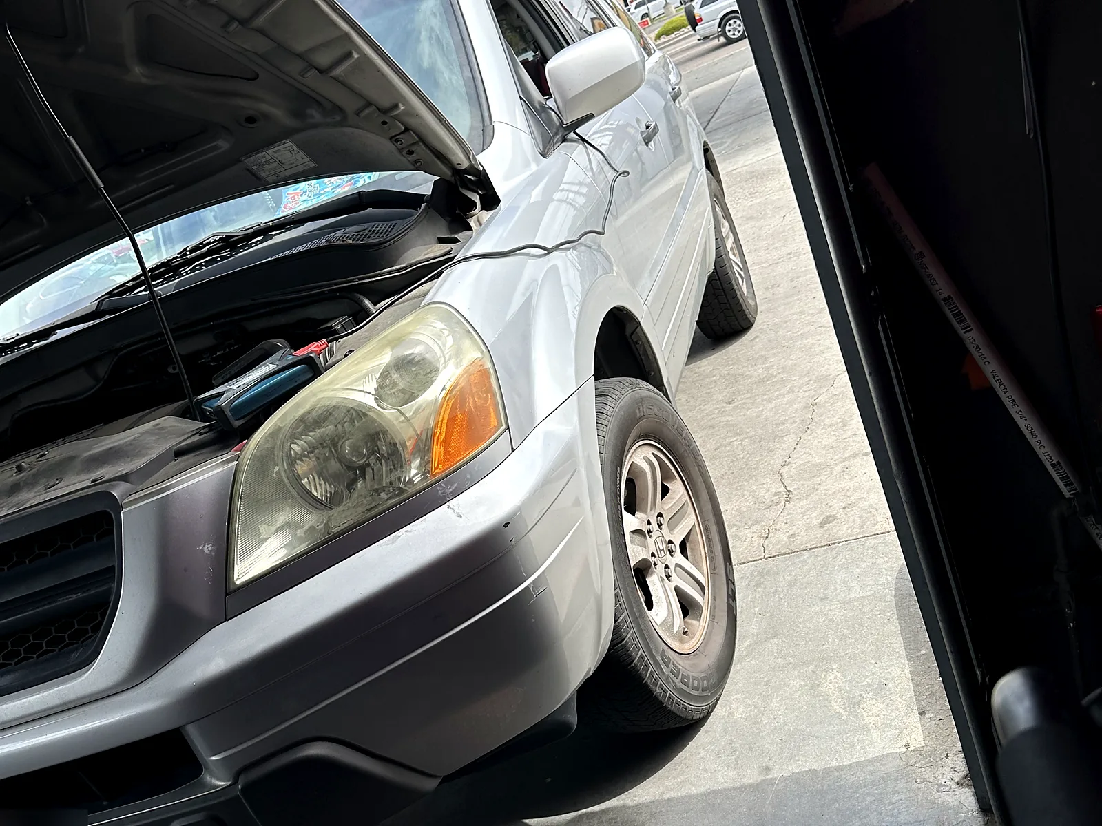 STAR smog check in Escondido, CA: Honda SUV with the hood open in our test bay