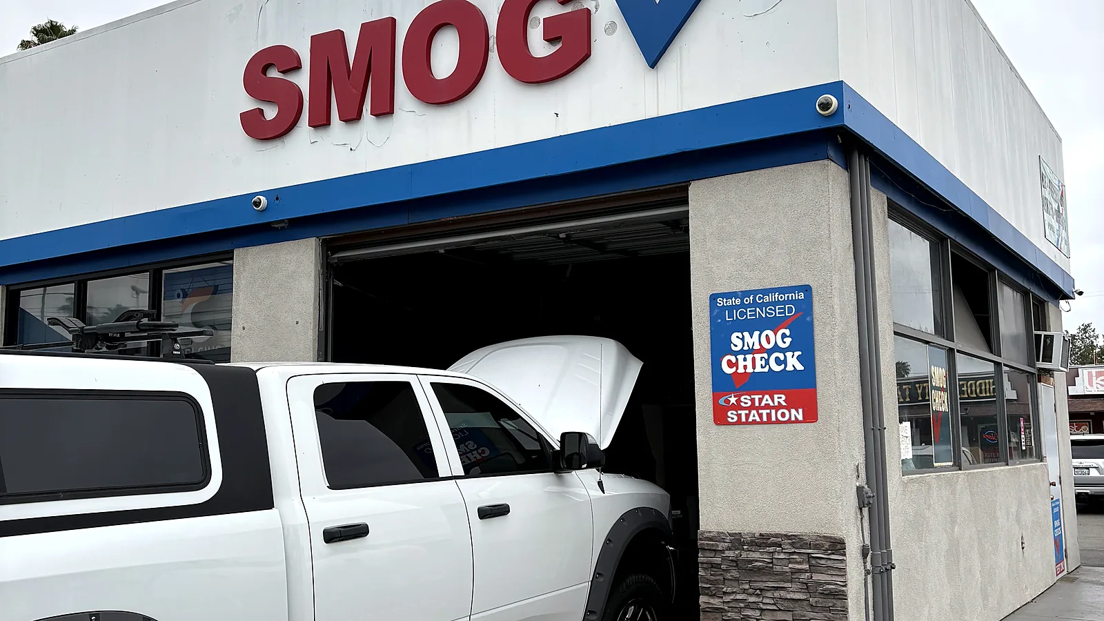 STAR smog check in Escondido, CA: pickup truck pulled into our test bay under the Smog sign on East Valley Parkway